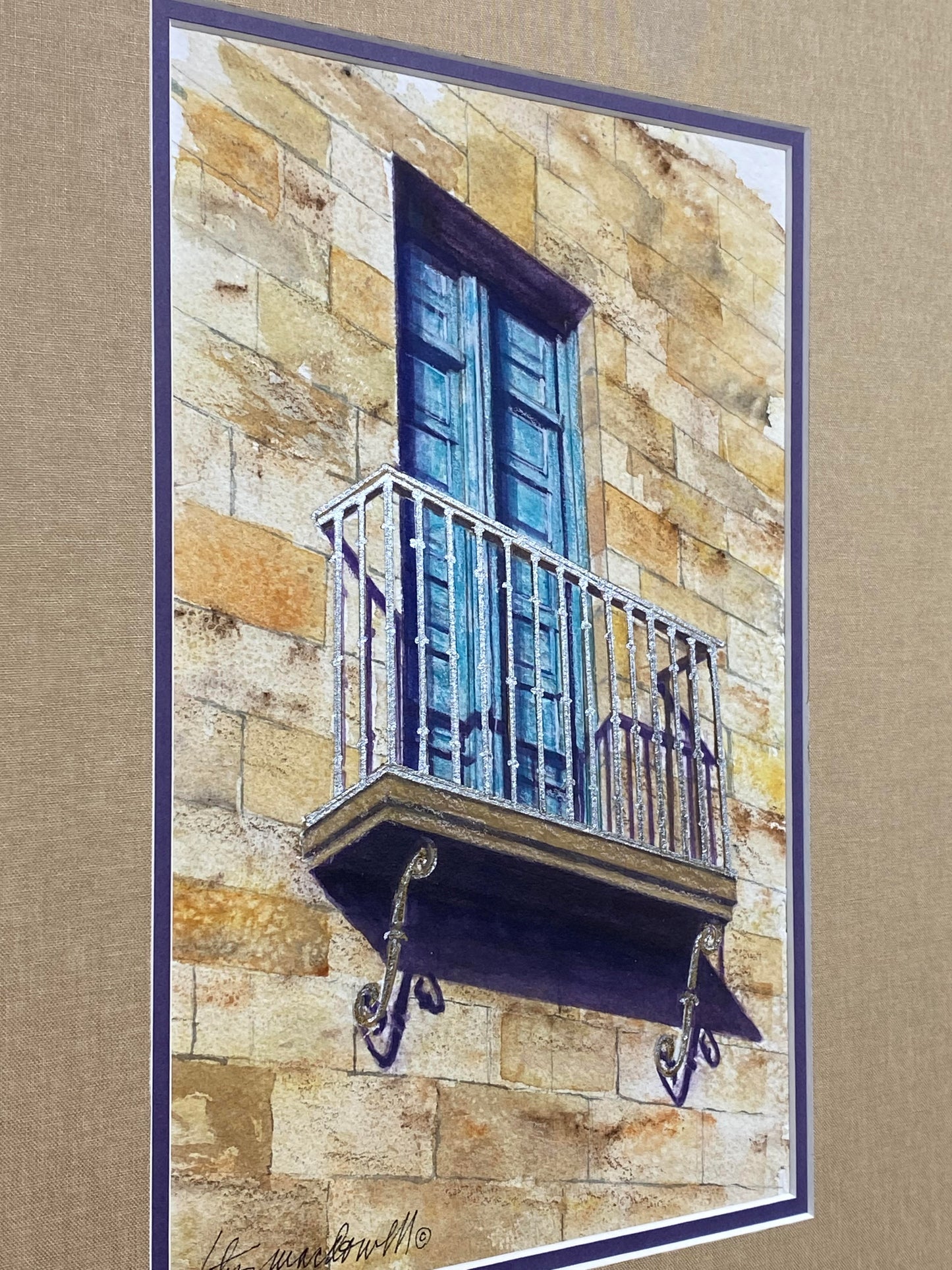 Blue Door- Portugal Original Watercolor Painting by Lotus MacDowell, Artworks WV: This lovely little watercolor shows the beauty of the afternoon sunlight Spilling down across a balcony. The door is old and weathered but it is flanked by a metallic silver railing – a great mixture of old worn out architecture with beautifully gilded detail.